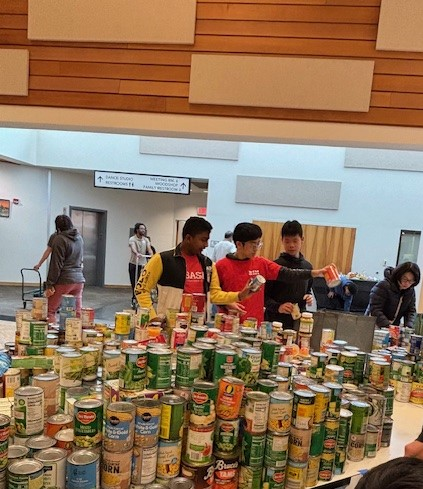 Student volunteers organizing donated food
